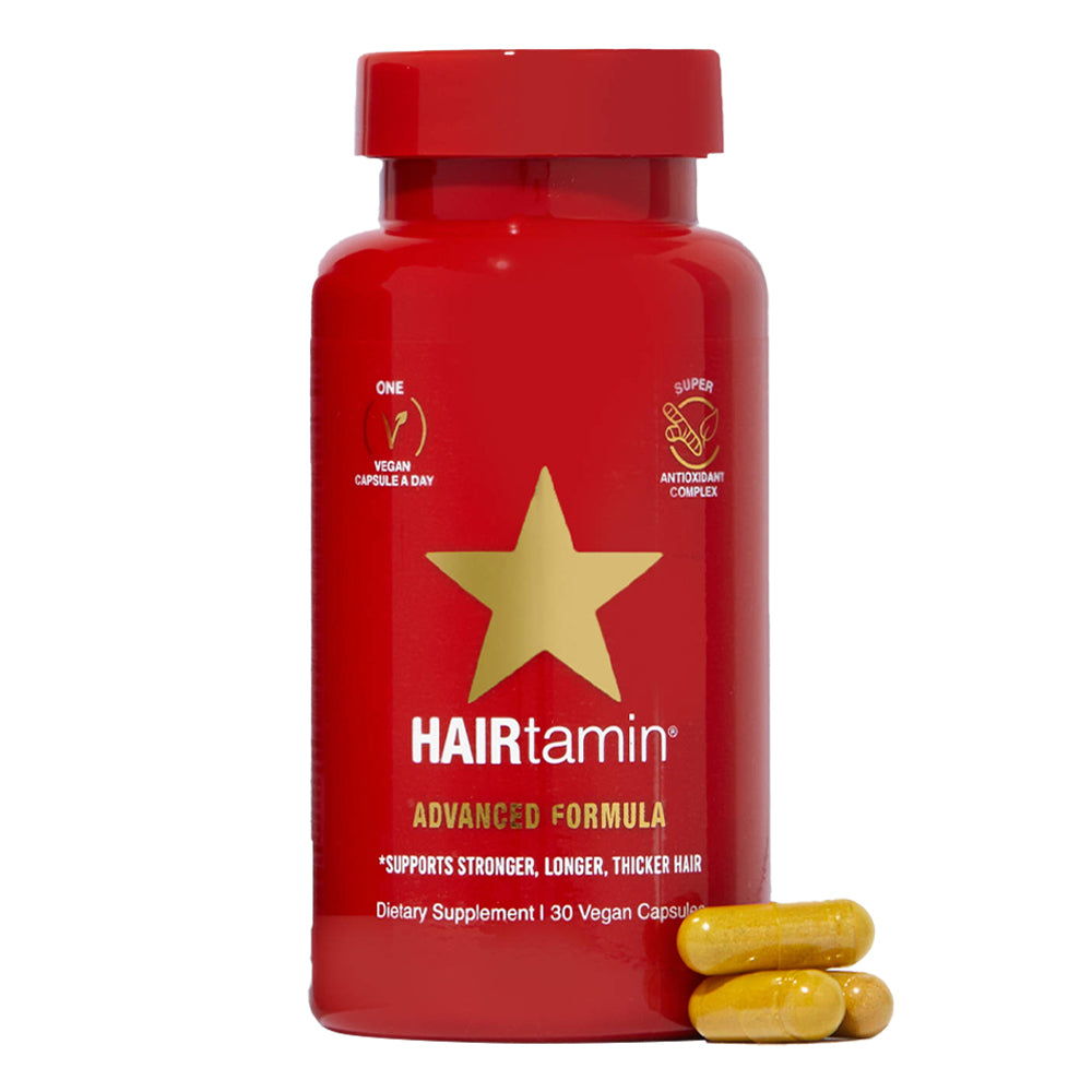 Red bottle of HAIRtamin supplement with yellow stars on a white background