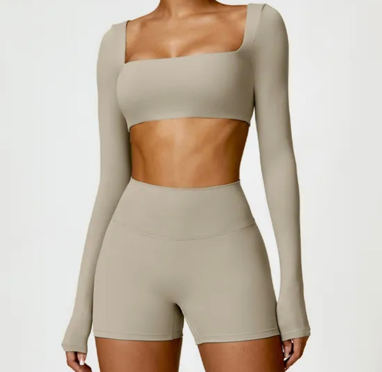 Beige long-sleeve crop top and shorts set on a white background