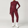 Maroon athletic outfit with long-sleeve top and leggings on a plain background