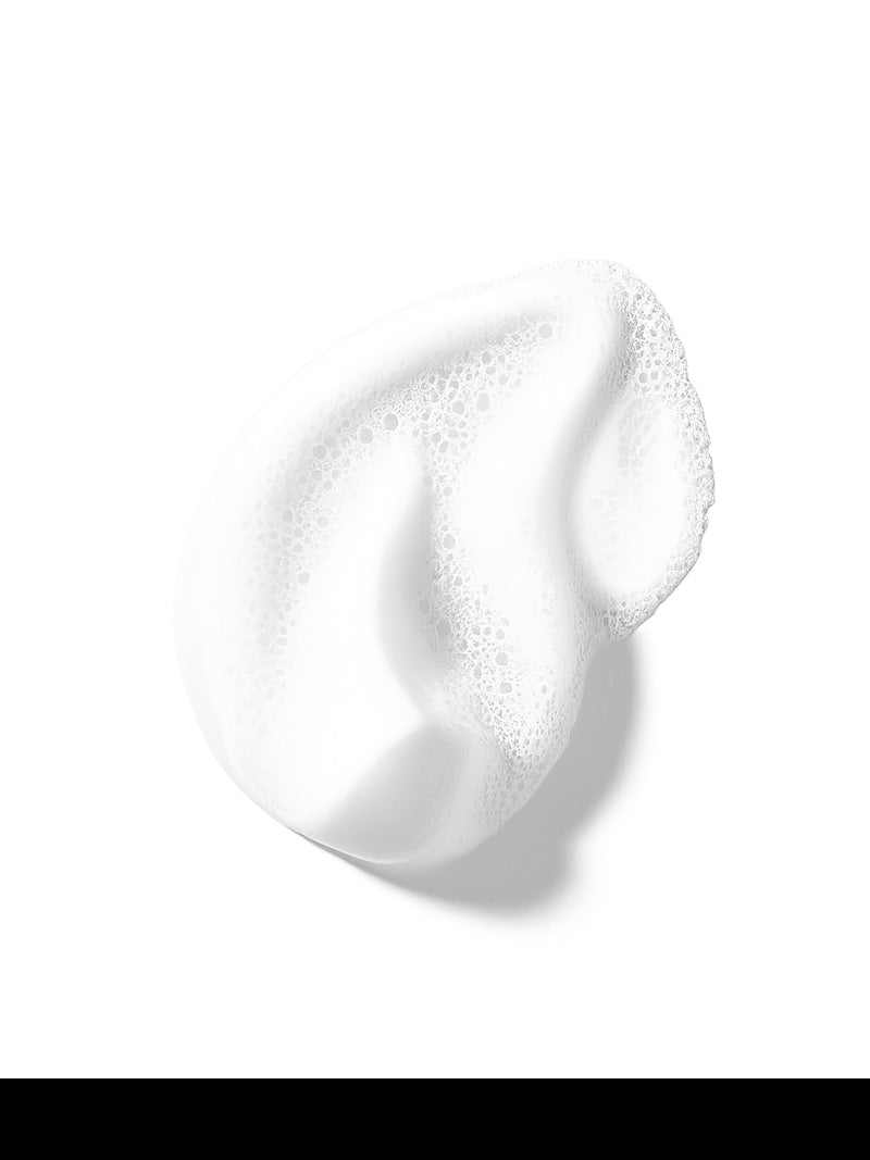 Close-up of a white cream or lotion smear on a white background