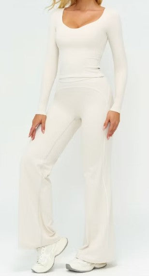 Person wearing a white outfit with a plain background