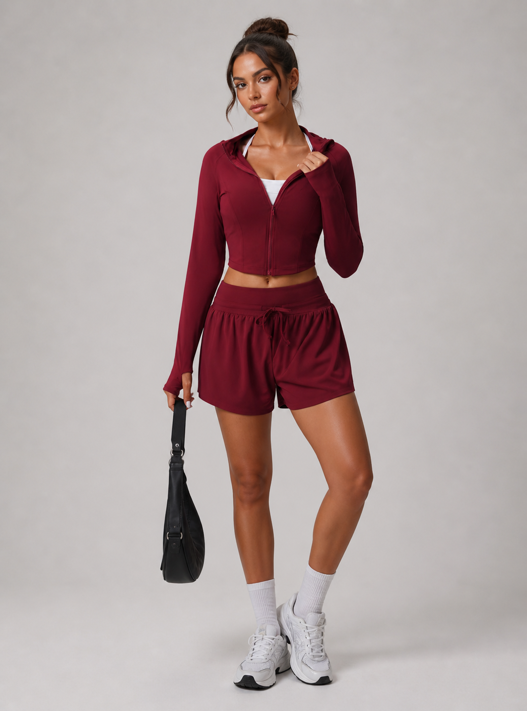 Woman wearing a red athletic outfit on a plain background