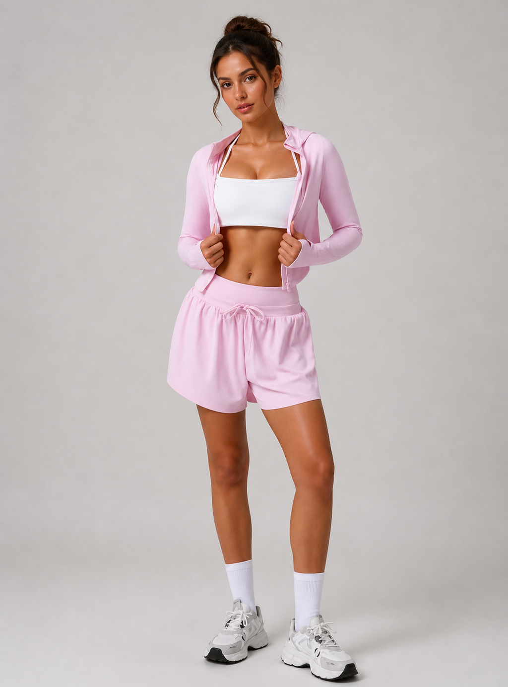 Woman wearing a pink athletic outfit on a plain background
