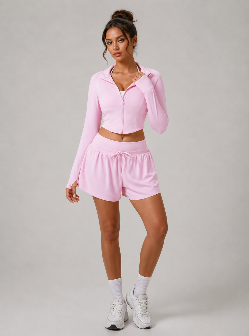 Woman wearing a pink athletic outfit on a gray background